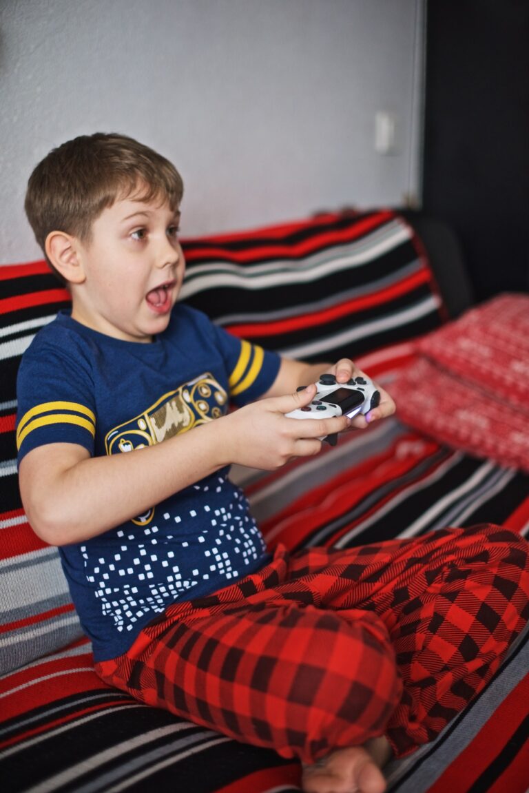 Young boy sitting very nervously on the sofa during video Game